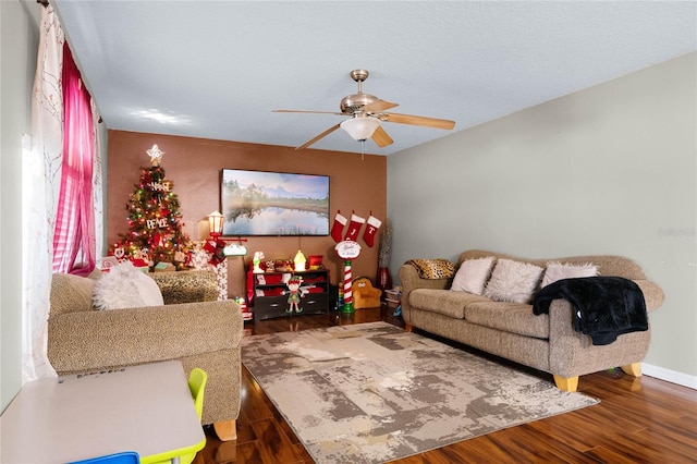 living room featuring ceiling fan and dark hardwood / wood-style floors