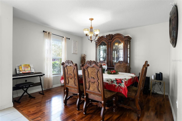 dining area with hardwood / wood-style flooring and a notable chandelier