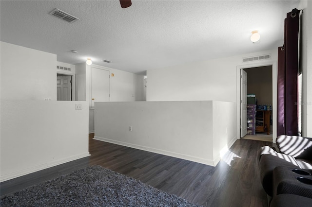 spare room with dark hardwood / wood-style flooring and a textured ceiling