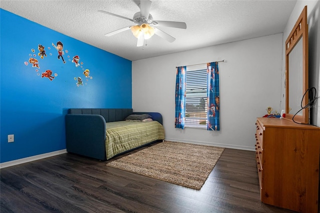 bedroom featuring a textured ceiling, ceiling fan, and dark wood-type flooring