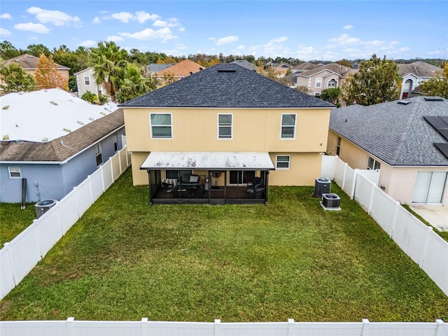 back of property featuring a yard, central AC unit, and a sunroom