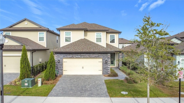 7959 Delwin Ln, Kissimmee, FL 34747 - view of front of property with a garage, decorative driveway, roof with shingles, and stone siding