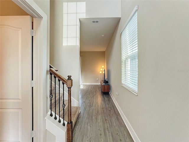 hallway with hardwood / wood-style floors