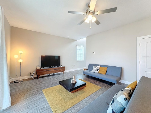 living room with hardwood / wood-style floors and ceiling fan