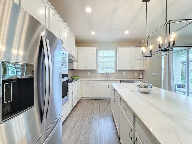 7959 Delwin Ln, Kissimmee, FL 34747 - kitchen featuring appliances with stainless steel finishes, plenty of natural light, light wood-style floors, recessed lighting, and white cabinets
