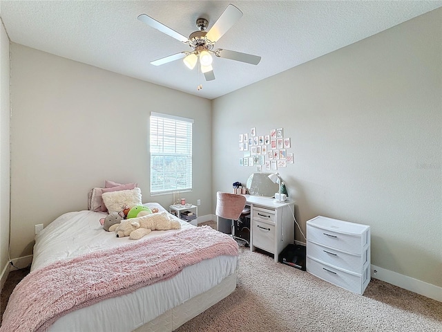 bedroom featuring ceiling fan, light colored carpet, and a textured ceiling