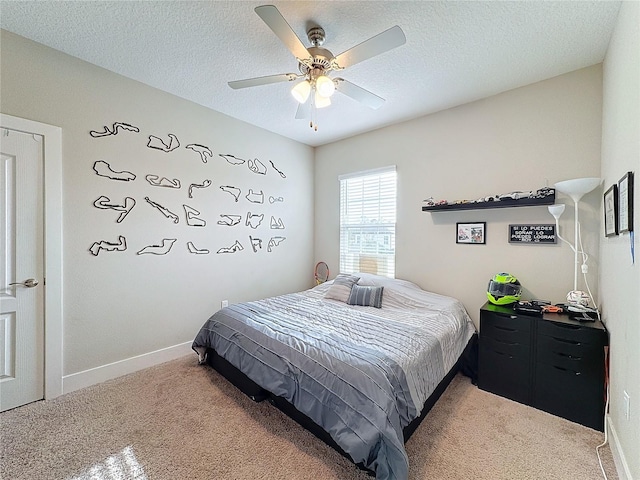 bedroom featuring a textured ceiling, carpet floors, and ceiling fan