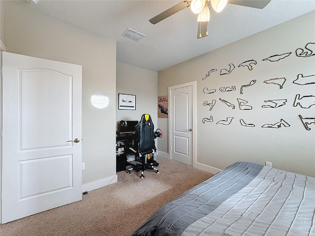 bedroom featuring carpet, a textured ceiling, and ceiling fan