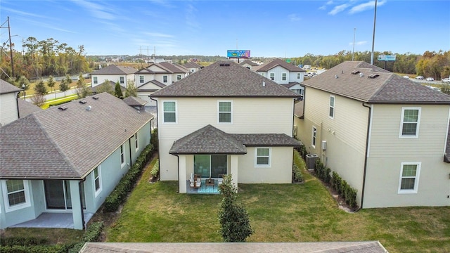 rear view of property with a yard, cooling unit, and a patio area