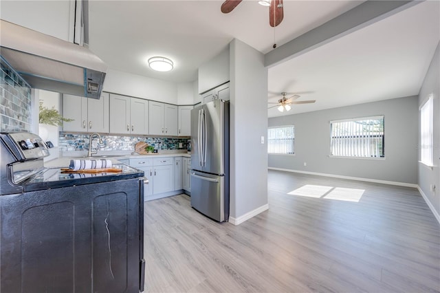 kitchen featuring ventilation hood, sink, electric range, stainless steel fridge, and light hardwood / wood-style floors