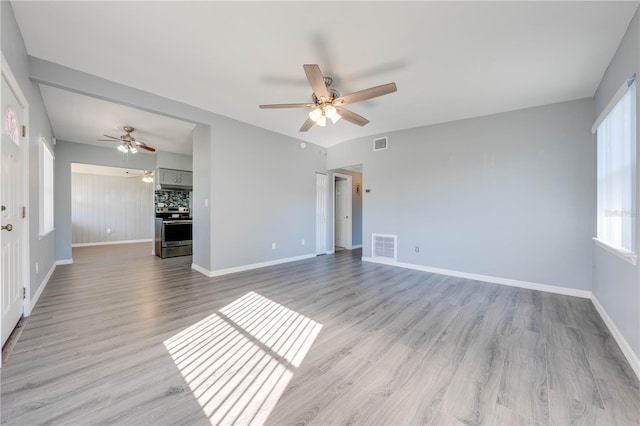 unfurnished living room featuring light hardwood / wood-style flooring and ceiling fan