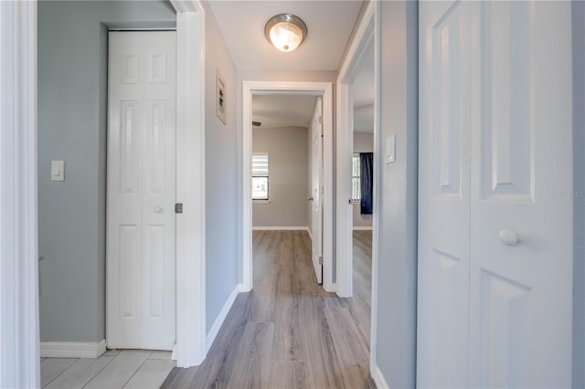 corridor with light hardwood / wood-style flooring