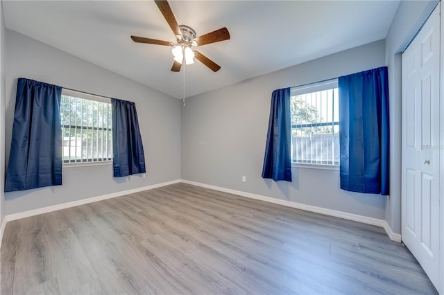 unfurnished room with plenty of natural light, ceiling fan, and light hardwood / wood-style flooring