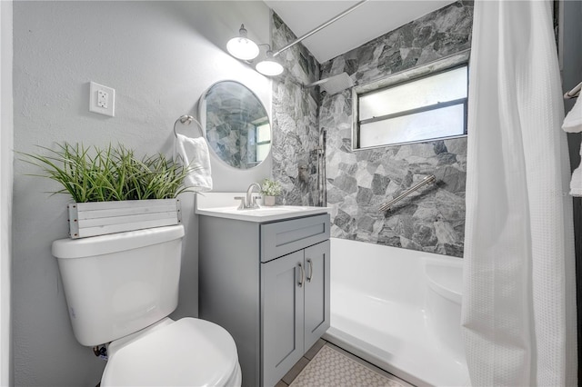 full bathroom with vanity, shower / bath combo, and toilet