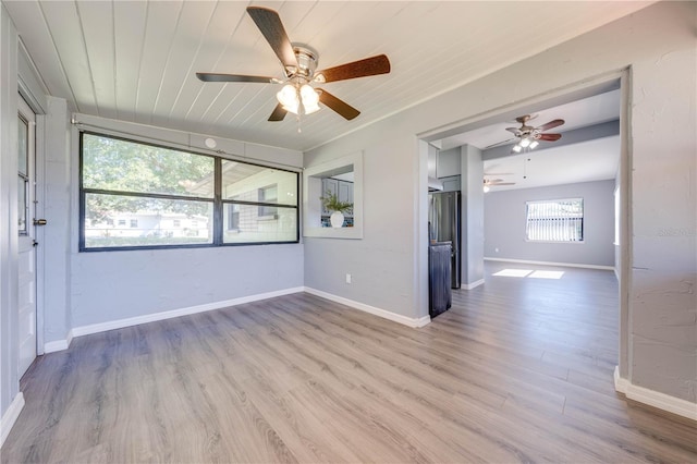 spare room with light hardwood / wood-style flooring and wood ceiling