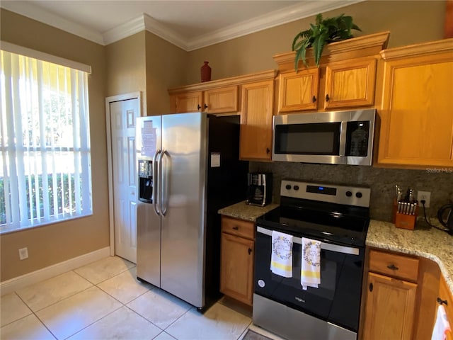 kitchen with light stone countertops, appliances with stainless steel finishes, backsplash, and light tile patterned flooring