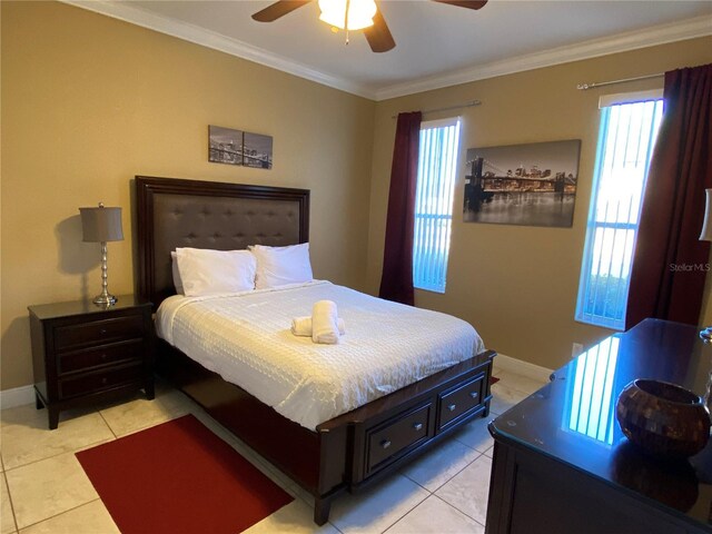 bedroom with ceiling fan, light tile patterned floors, and ornamental molding