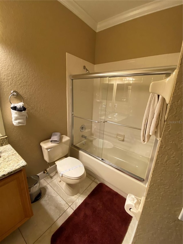 full bathroom with combined bath / shower with glass door, tile patterned floors, ornamental molding, vanity, and toilet