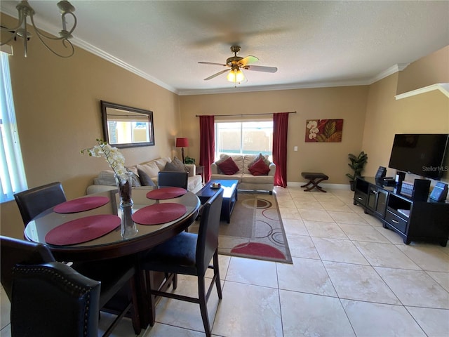 tiled dining room featuring a textured ceiling, ceiling fan, and crown molding