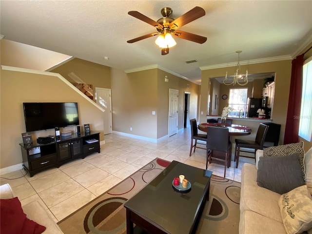 living room featuring crown molding, light tile patterned floors, and ceiling fan with notable chandelier