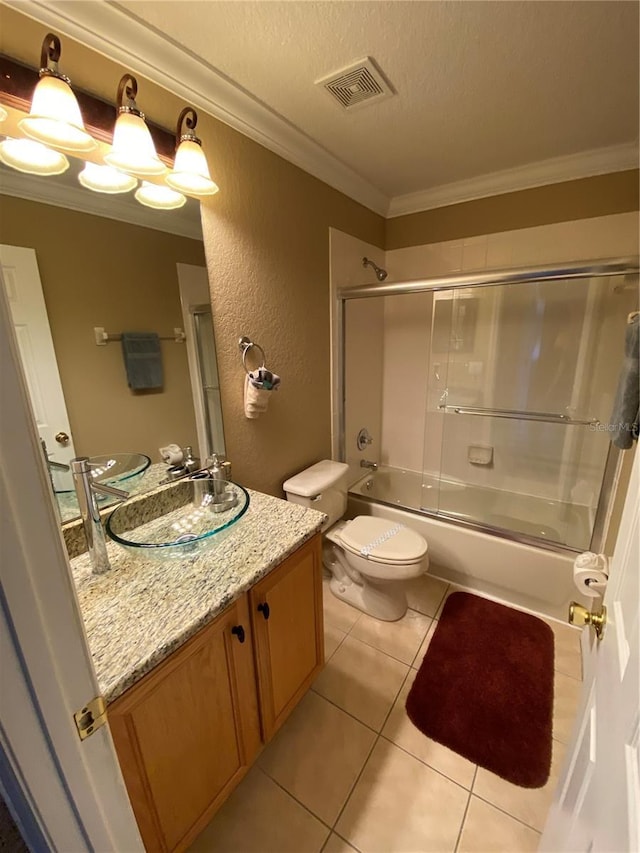 full bathroom featuring vanity, shower / bath combination with glass door, tile patterned flooring, toilet, and ornamental molding