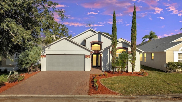 view of front of property featuring a yard and a garage