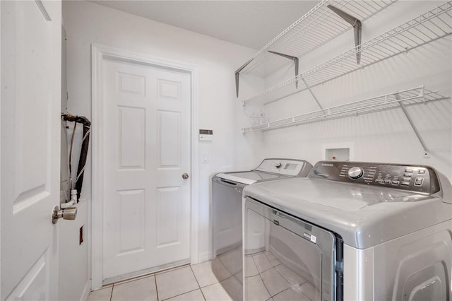 laundry room with light tile patterned floors and independent washer and dryer