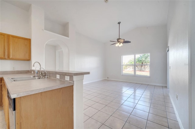 kitchen with ceiling fan, sink, high vaulted ceiling, kitchen peninsula, and light tile patterned floors