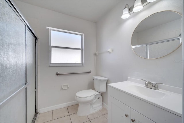 bathroom featuring tile patterned flooring, vanity, toilet, and a shower with door