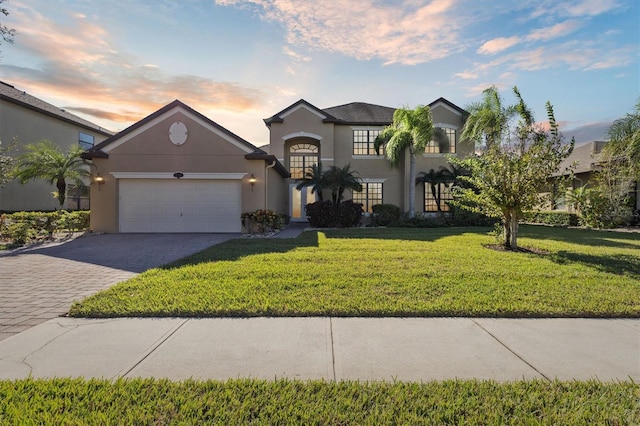 view of front of property featuring a yard and a garage