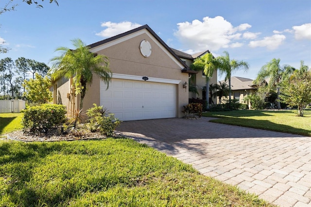 view of front of property with a garage and a front lawn