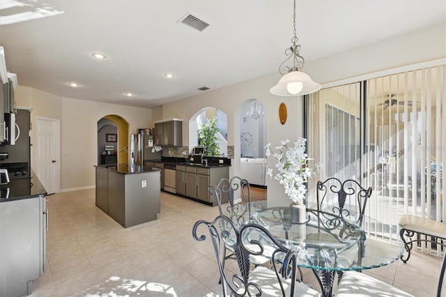 dining space featuring sink and light tile patterned floors