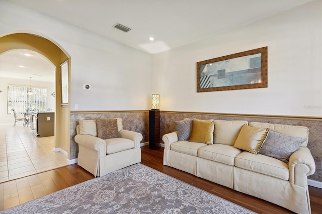 living room featuring hardwood / wood-style flooring and tile walls