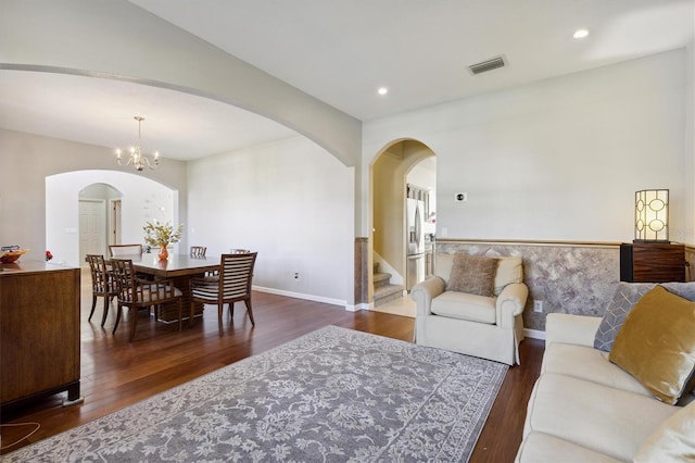 living room featuring dark hardwood / wood-style floors and a chandelier