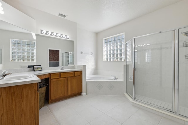 bathroom with tile patterned flooring, shower with separate bathtub, and vanity