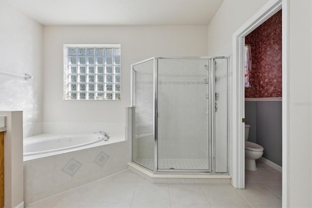 bathroom with tile patterned flooring, shower with separate bathtub, and toilet