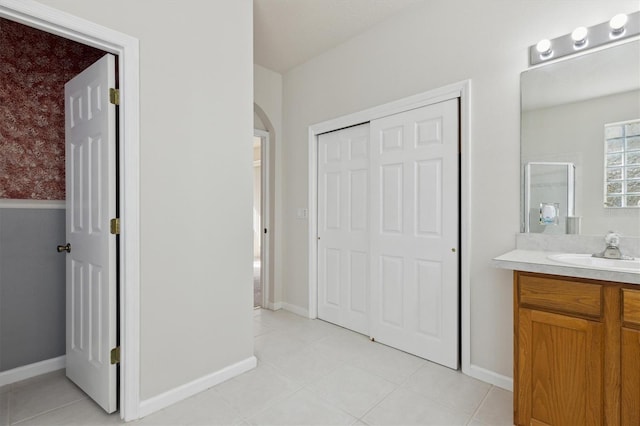 bathroom featuring tile patterned flooring, vanity, and walk in shower