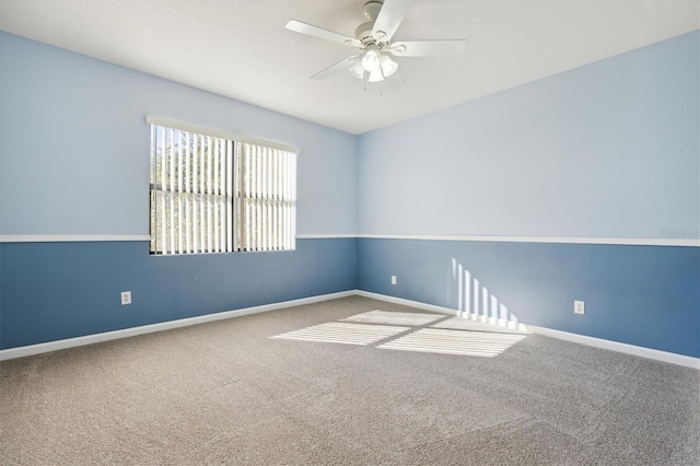 empty room featuring ceiling fan and carpet floors