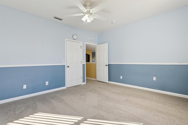 spare room featuring ceiling fan and carpet floors