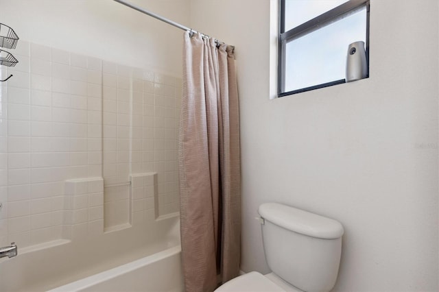 bathroom with shower / bath combination with curtain and toilet