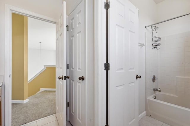 bathroom with tiled shower / bath combo and tile patterned floors