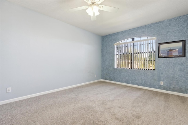 empty room featuring ceiling fan and carpet floors