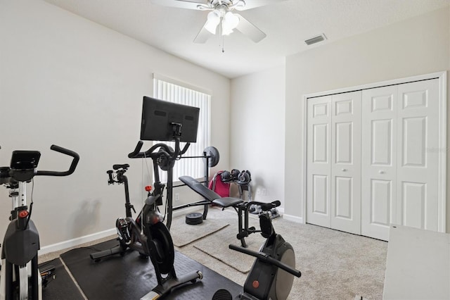 workout area featuring ceiling fan and light carpet