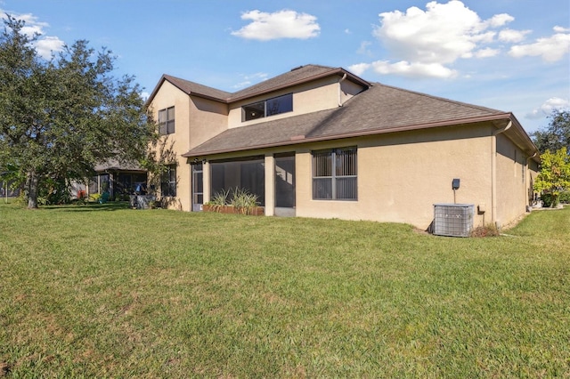 back of house featuring a lawn and central AC unit