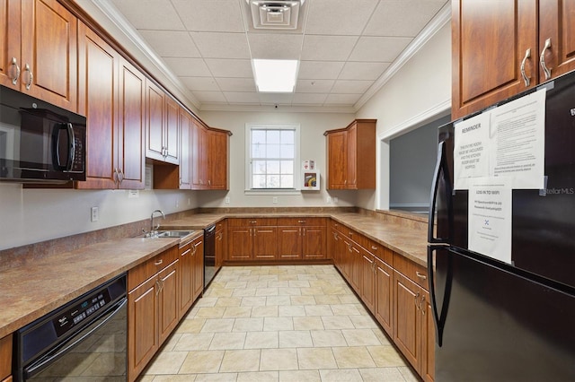 kitchen featuring sink, a drop ceiling, crown molding, light tile patterned floors, and black appliances