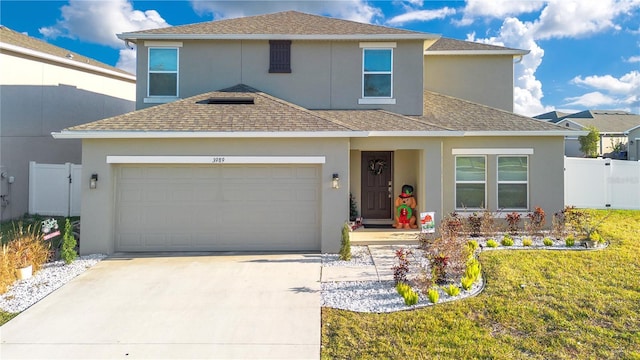 view of front property featuring a garage and a front yard