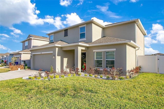 view of front of property featuring a front yard and a garage