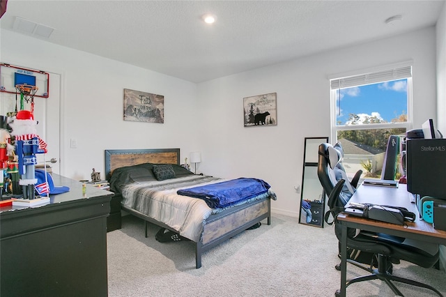 bedroom featuring carpet and a textured ceiling