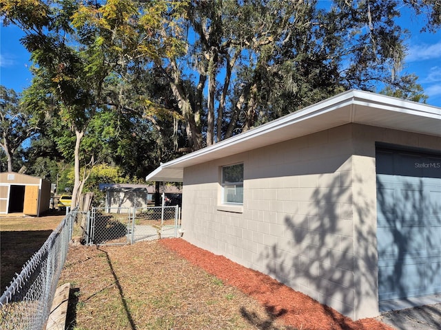 view of side of home featuring an outdoor structure and a garage