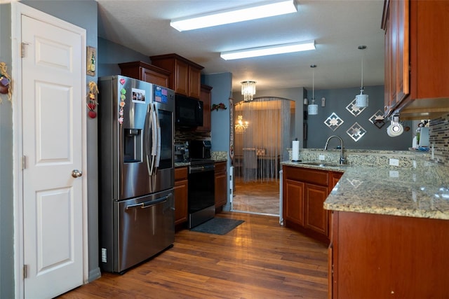 kitchen featuring pendant lighting, stainless steel appliances, dark wood-type flooring, and sink